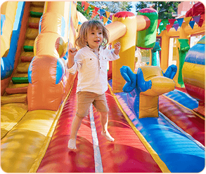Kid playing with inflatable slide
