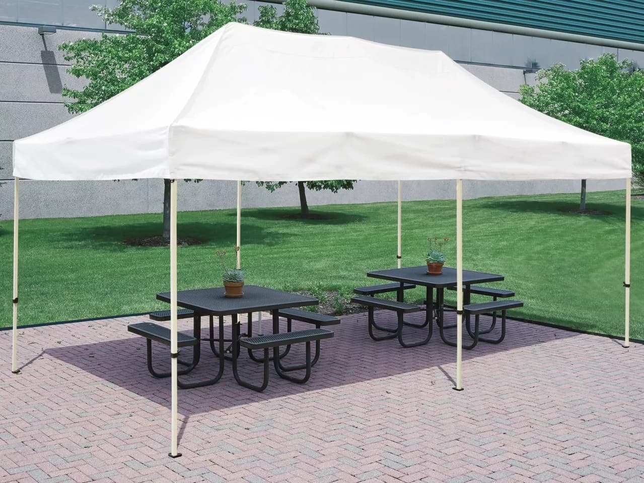 Outdoor front view of the 10x20 pop-up canopy tent shading picnic tables on brick patio.