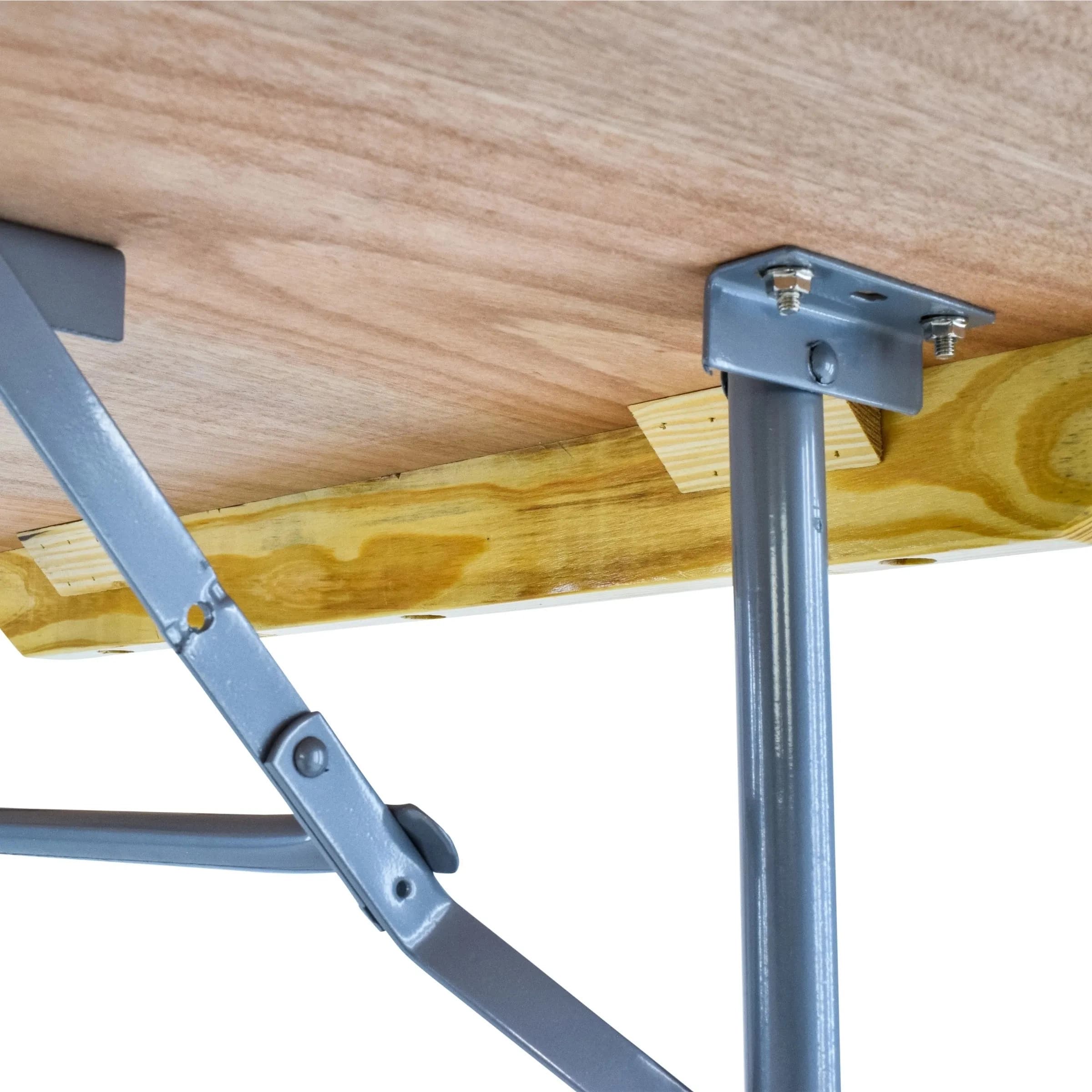Close-up view of the hinges connecting the table's top to the folding leg frame, showing construction details.
