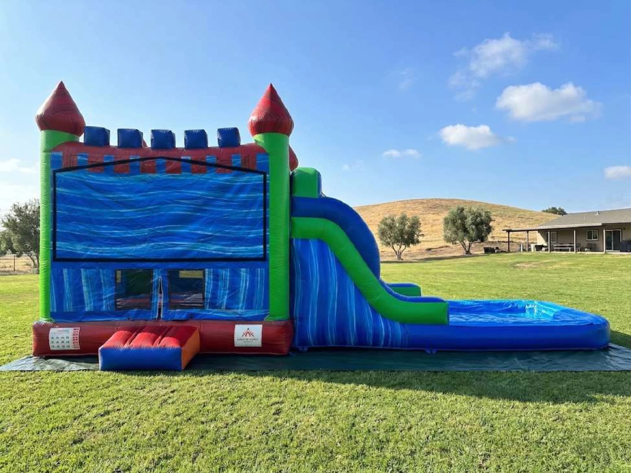 Front hero view of the 5 in 1 Ocean Wave Castle Combo showing main features and design.