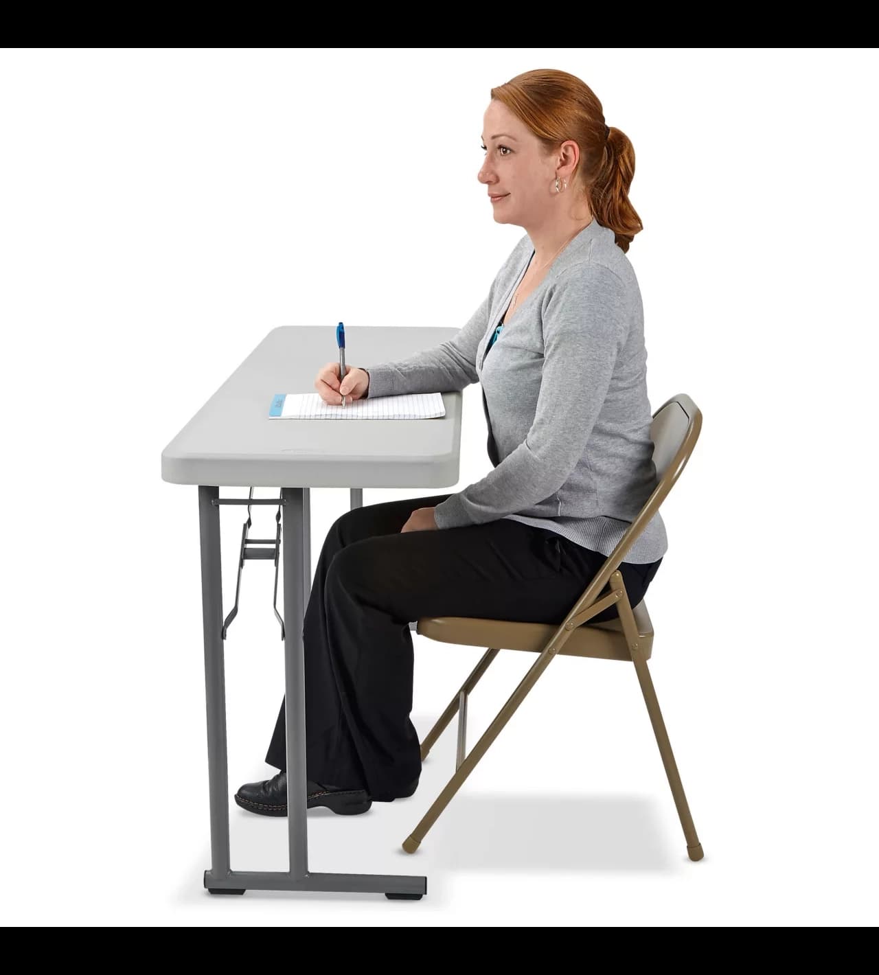Side view of the 6-Foot White Plastic Skinny Rectangular Table with a woman sitting on a char using it.