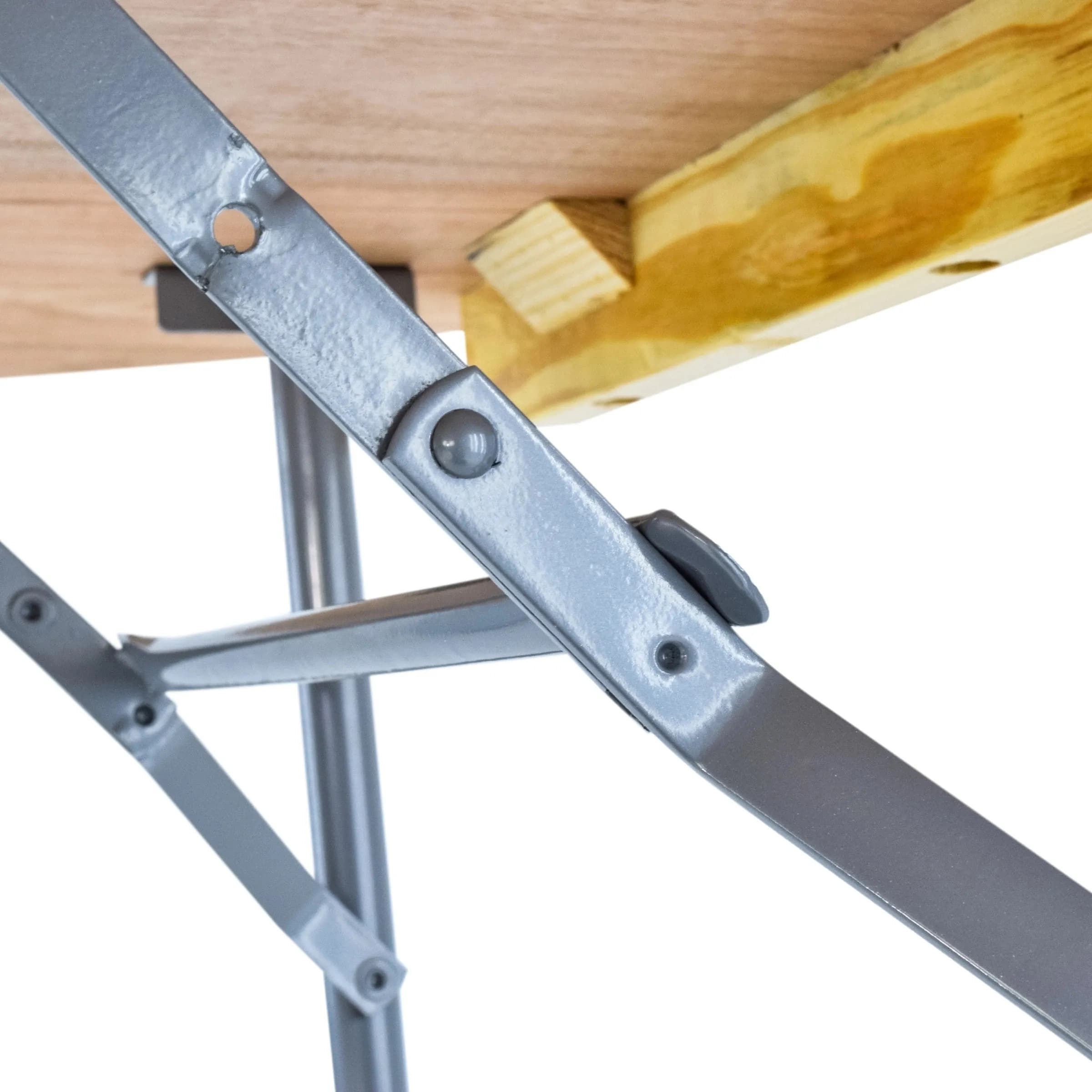 Close-up view of the hinges connecting the table's top to the folding leg frame, showing construction details.