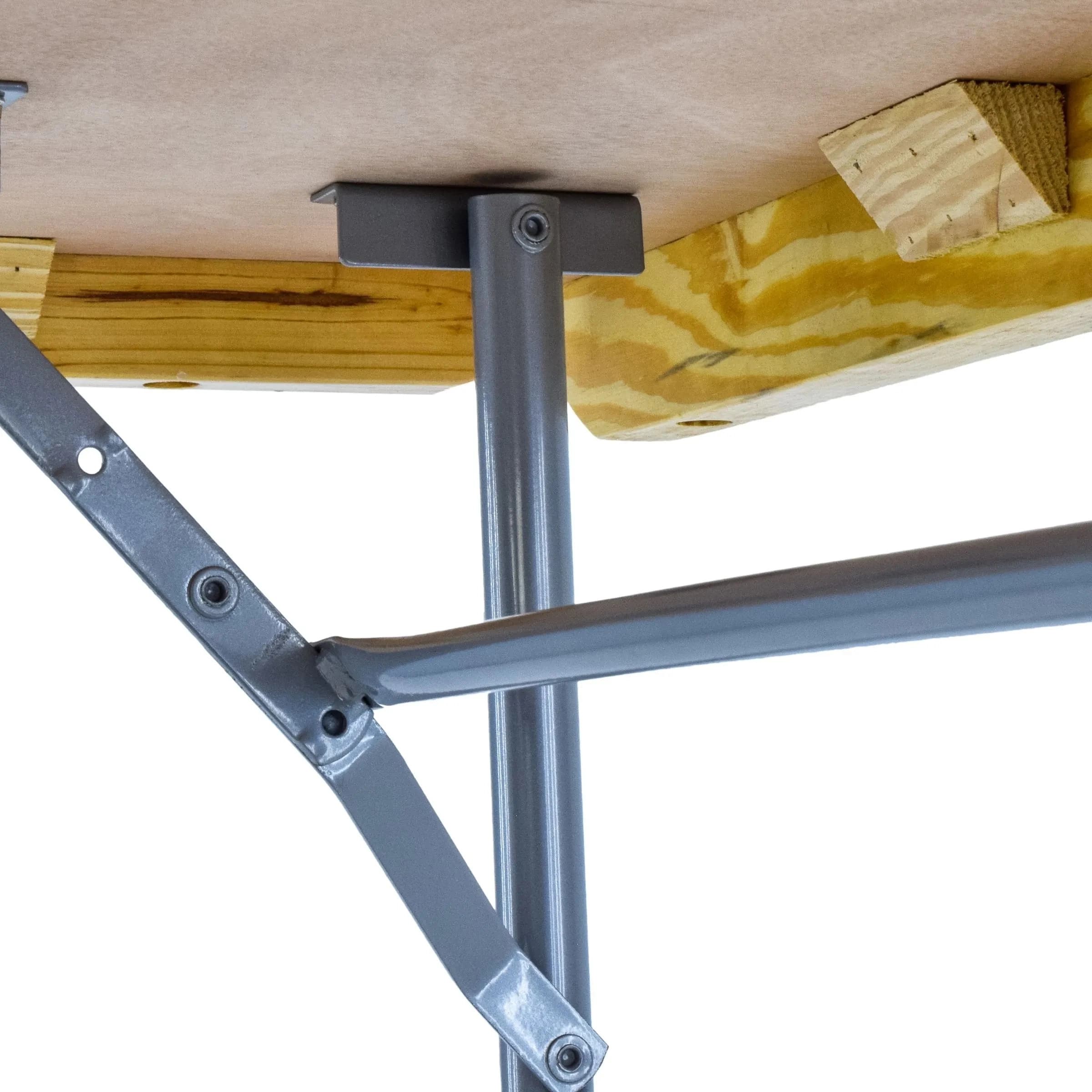 Close-up view of the hinges connecting the table's top to the folding leg frame, showing construction details.