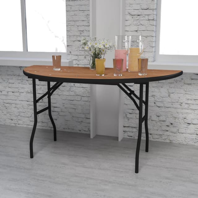 Setup view of the 72-inch natural wood half-moon table with items placed on top for serving or display purposes.