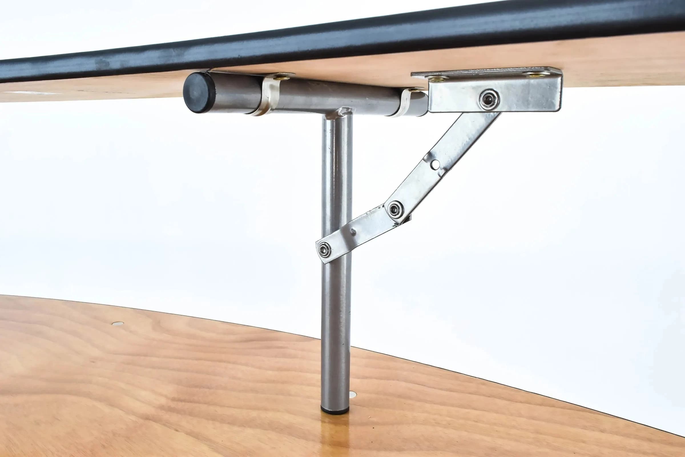 Close view of the hinge mechanism connecting both tiers on the extended serpentine bar table for secure attachment.