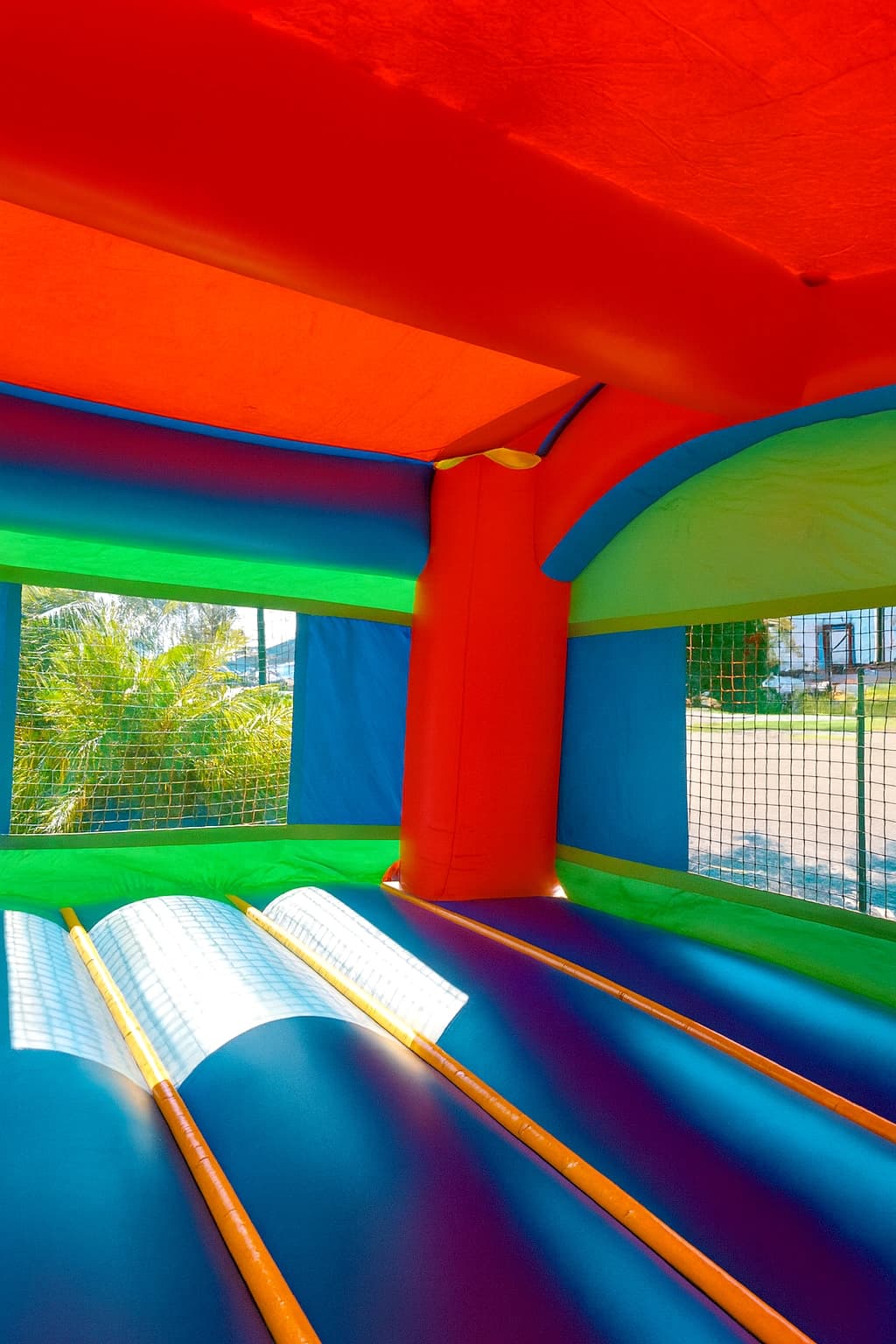 Alternate interior angle of the Castle Mini Slide Party Combo showing open jump area and mesh walls.