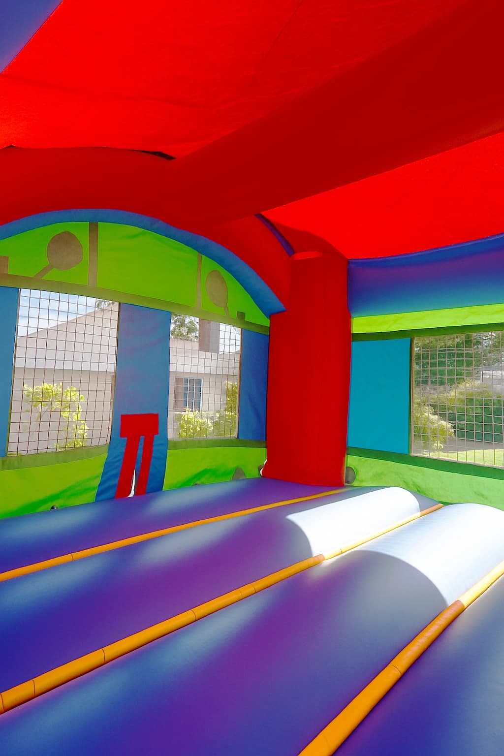 Interior view of the Castle Mini Slide Party Combo showing entry ramp and bounce space under colorful roof.
