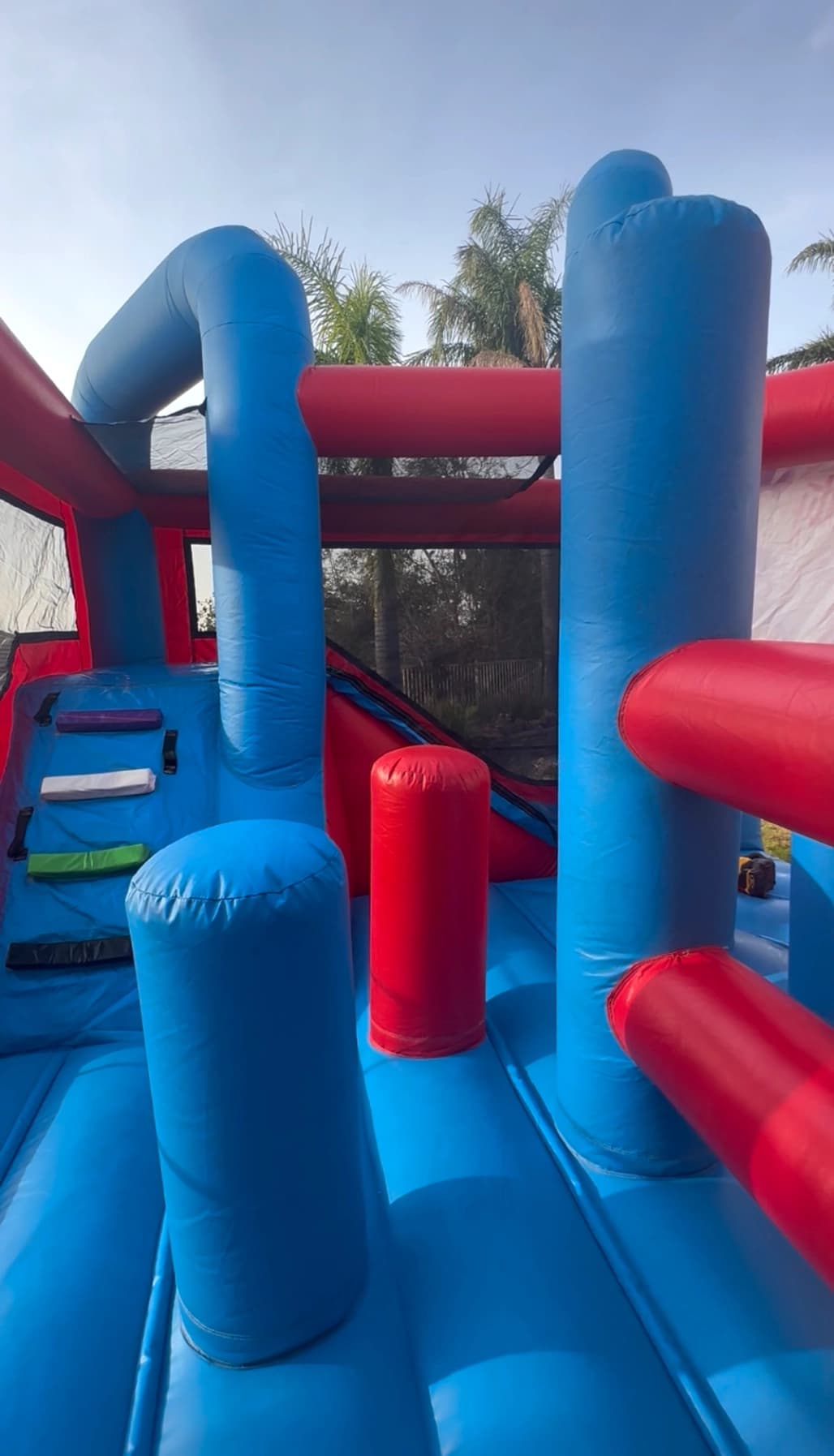 Interior view of the Disney Minnie Mouse combo showing bounce area, climb wall, and slide entrance.