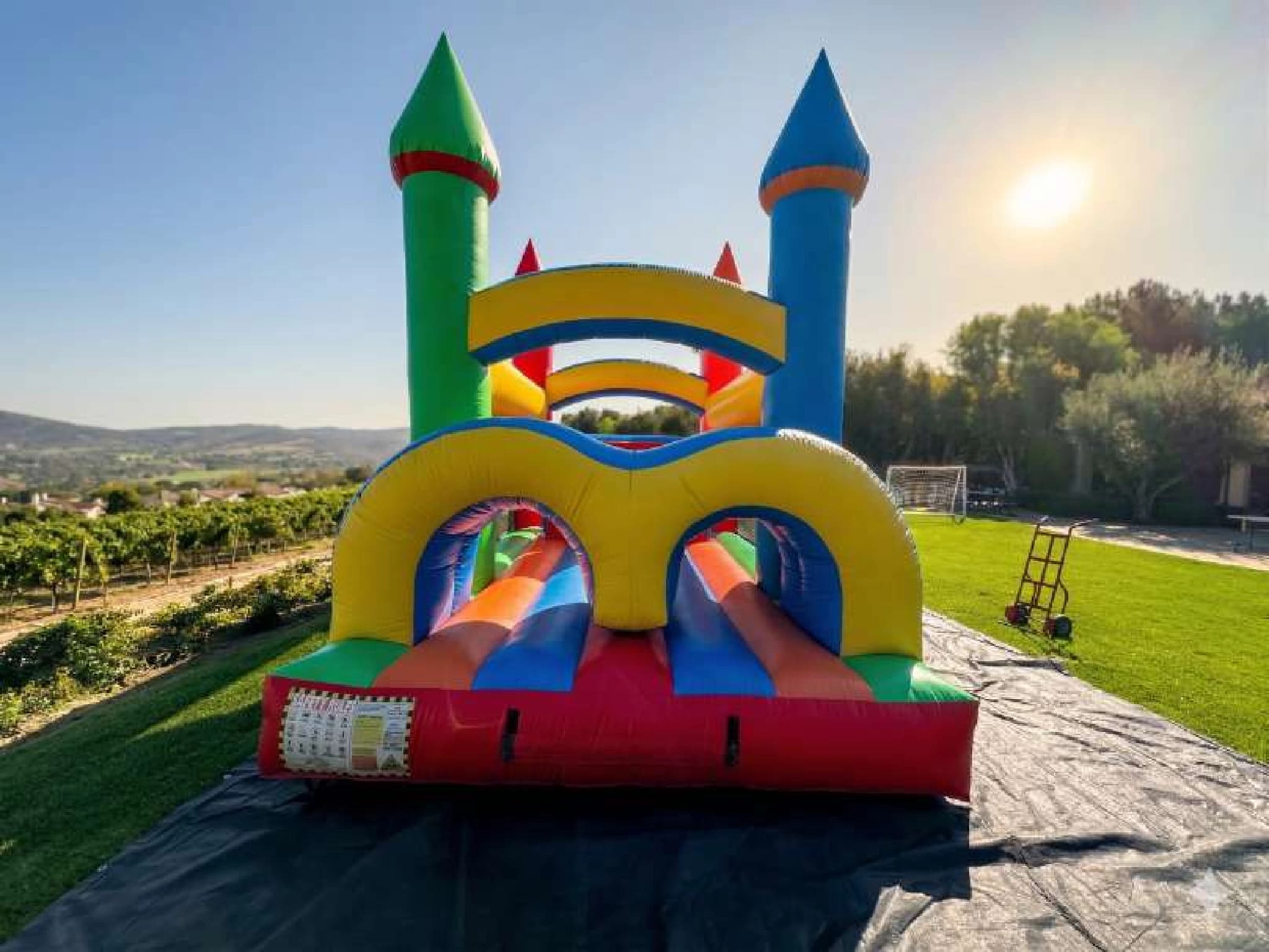 Outdoor front angle of the Extended Obstacle Course with Slide Combo set up for an event.