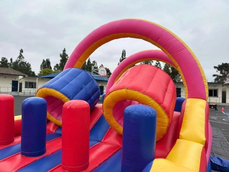 Outdoor front angle of the Funnel Run Climb & Slide Course set up for an event.