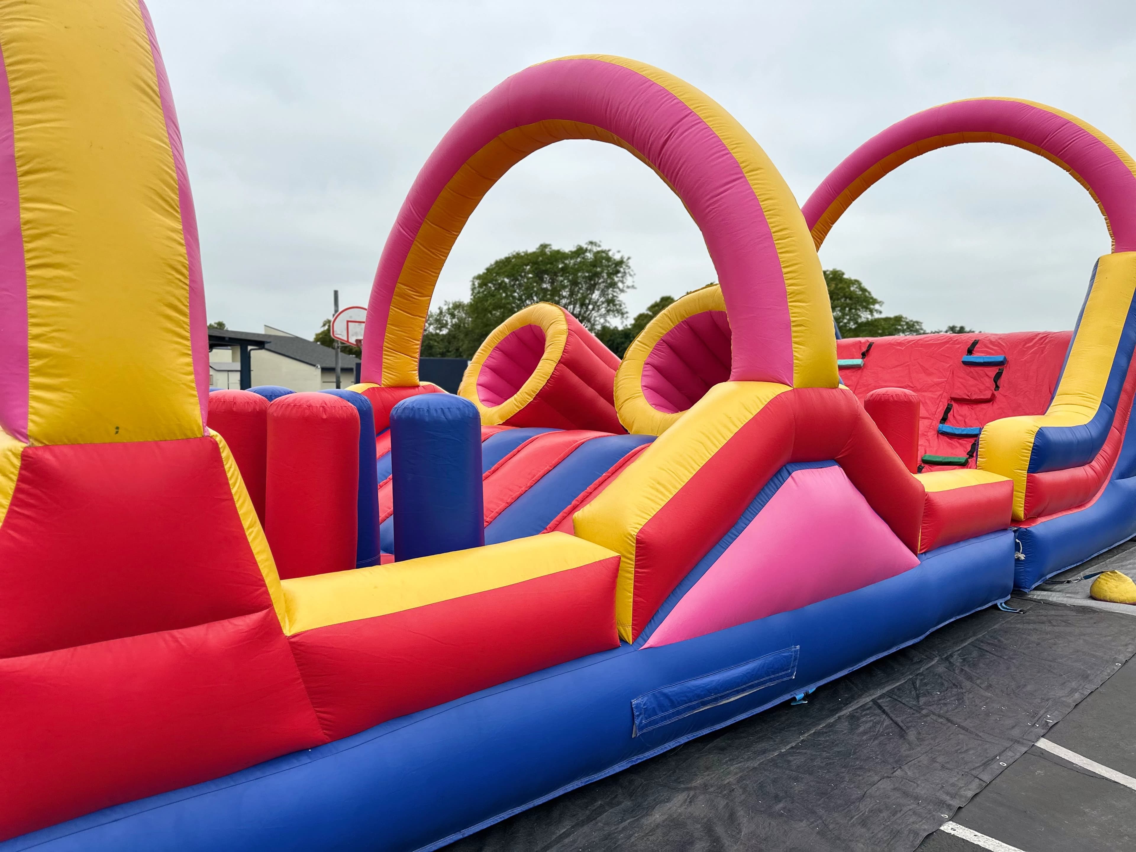 Outdoor view of the Funnel Run Course highlighting large arches and inflatable entry area on pavement.
