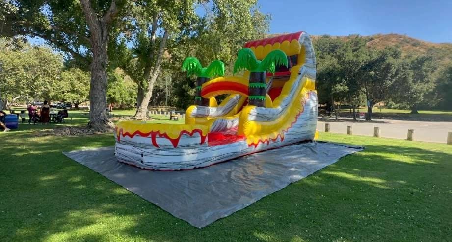Outdoor front angle of the Island Volcano Splash Tropical Water Slide set up for an event.