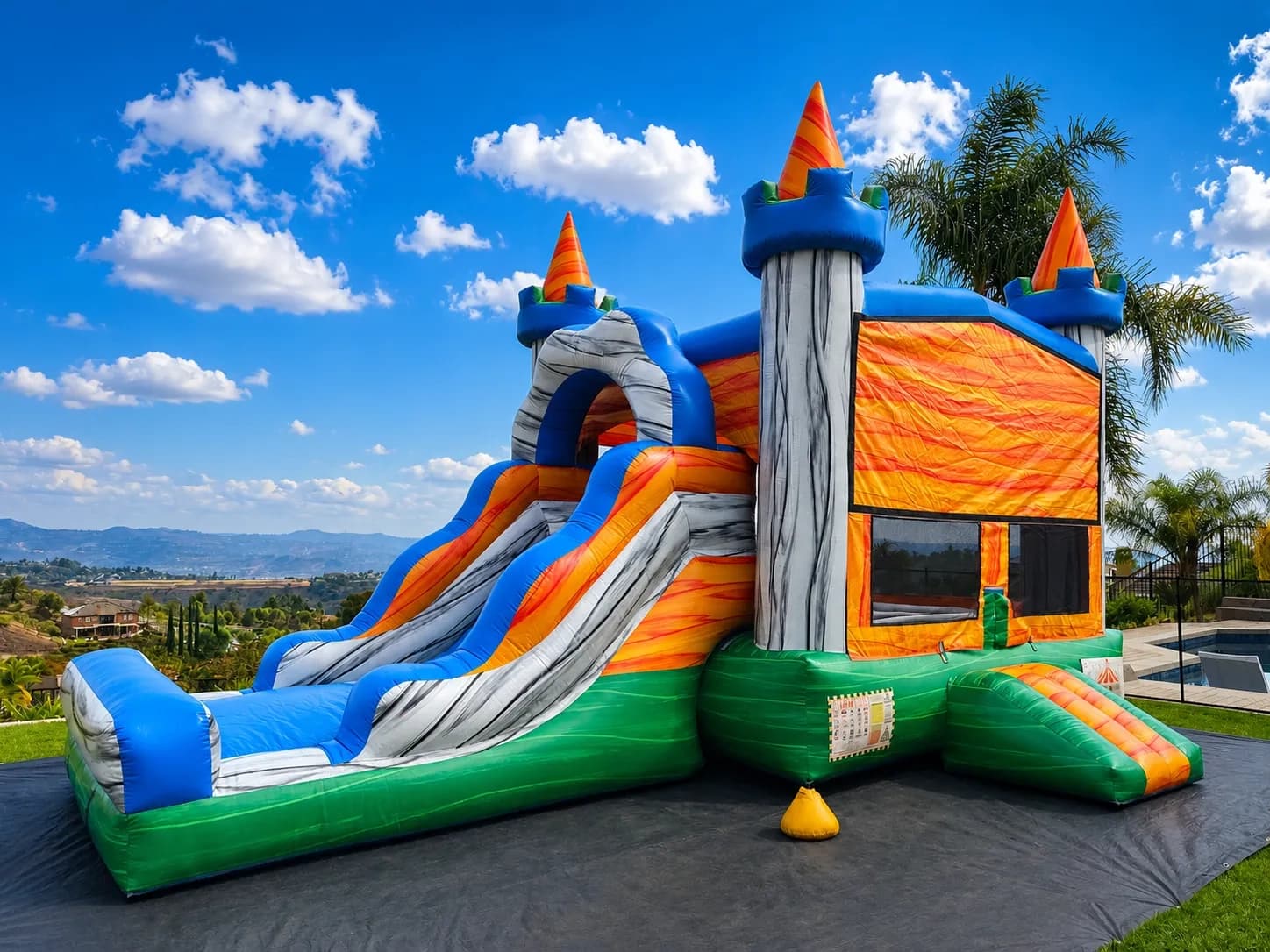 Front view of the Jurassic Adventure 4-in-1 Combo showing dinosaur graphics, slide, and climbing wall.