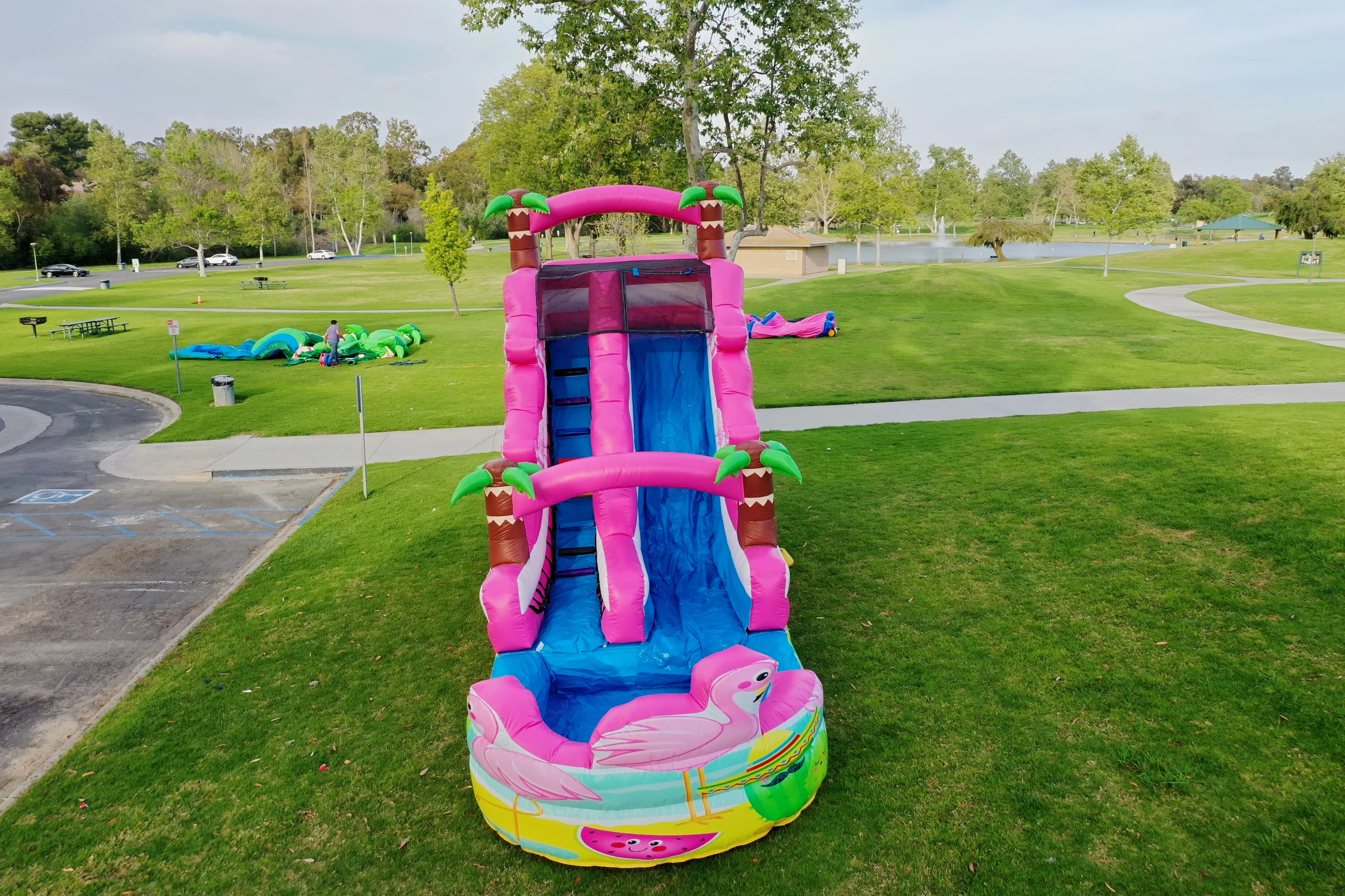 Front view of the Pink Flamingo Paradise Water Slide showing climb stairs, top platform, and water sprayer system.