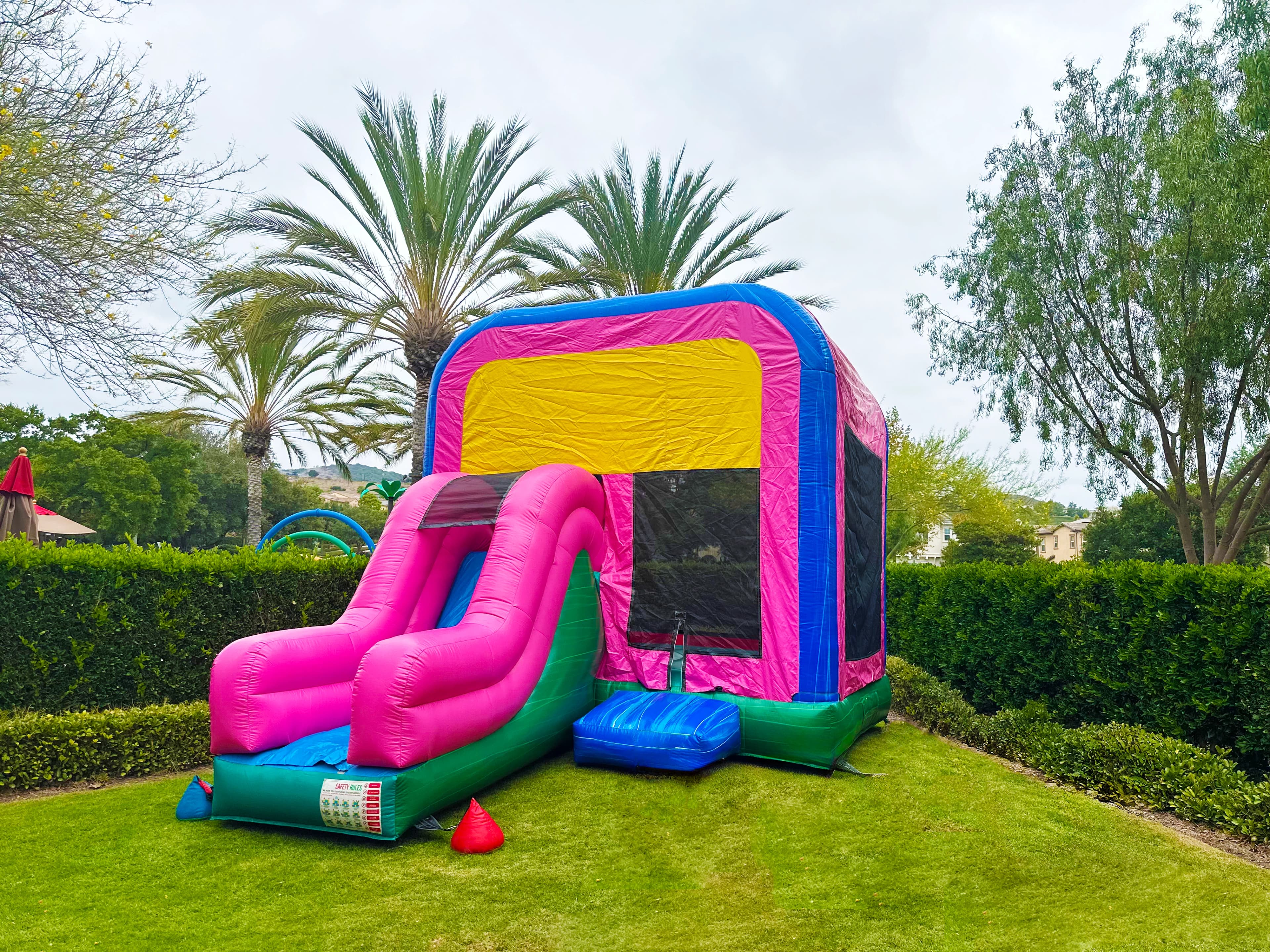 Outdoor front view of the Popular Pinko Combo Jumper showing entry step, slide area, and vivid character art.