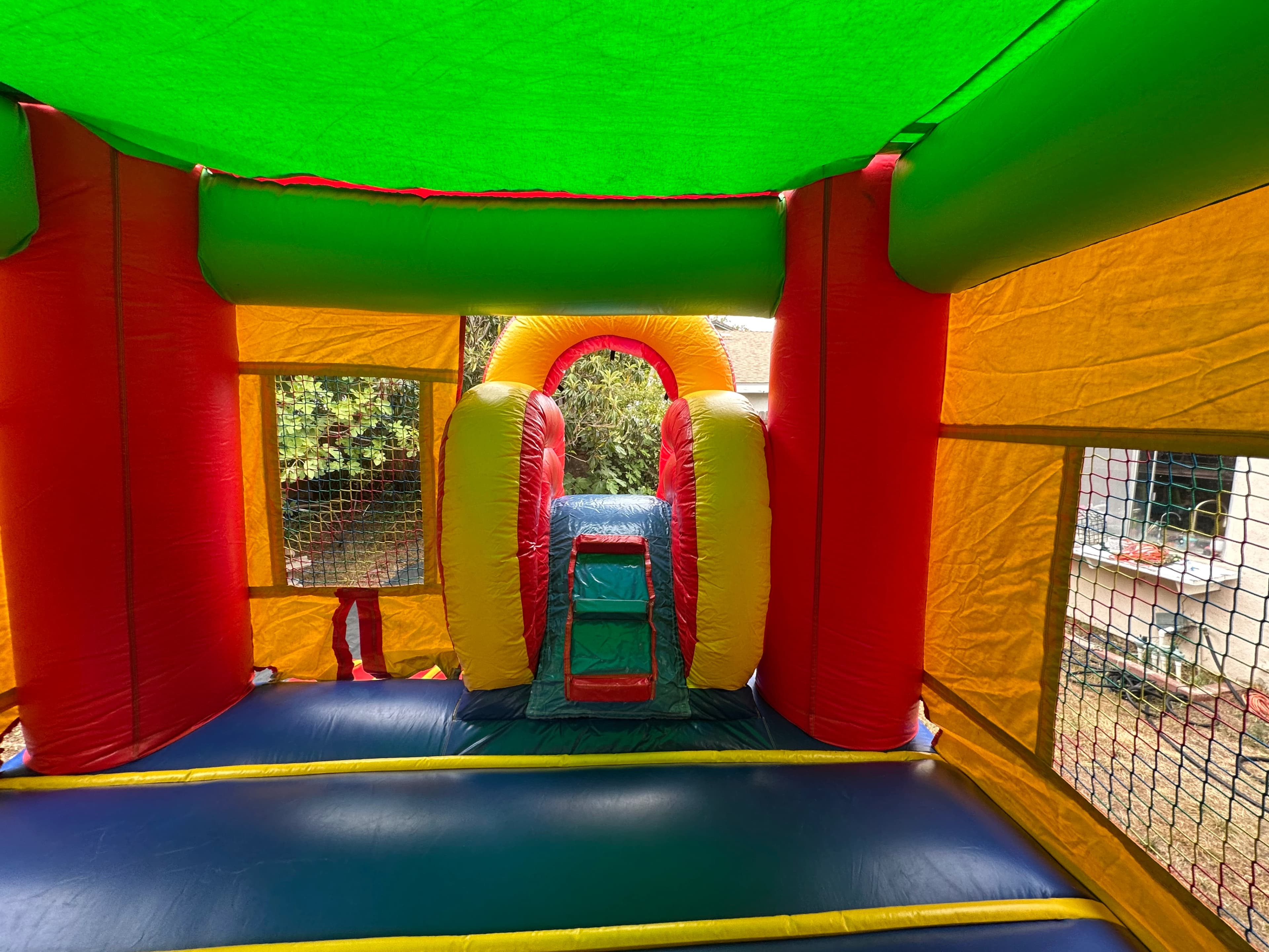 Close-up of the Rainbow Castle Combo climbing wall with colorful grips and rainbow details.