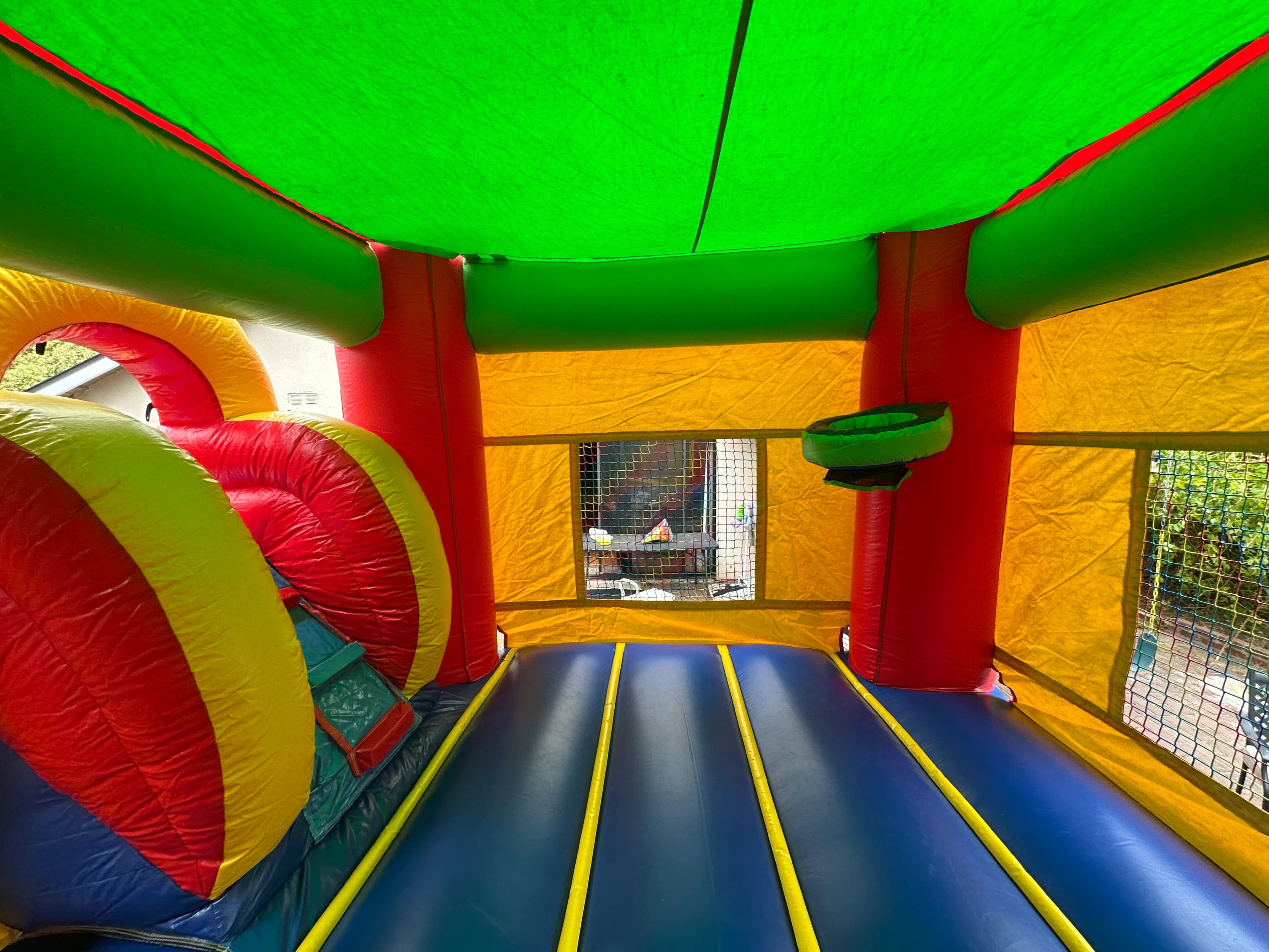Close-up of the Rainbow Castle Combo wide slide showing the rainbow-colored sliding lane.