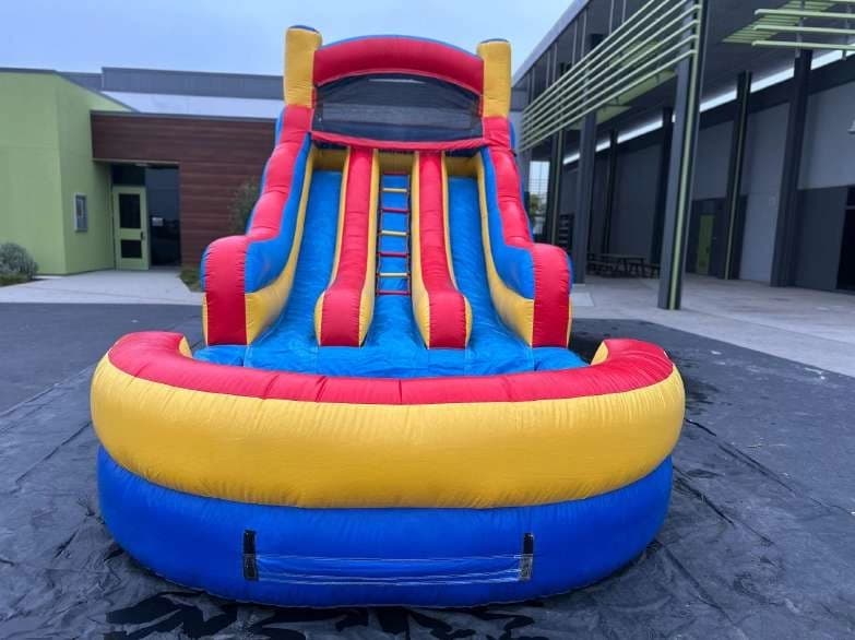 Outdoor front angle of the Red Dual Lane Water Slide set up for an event.