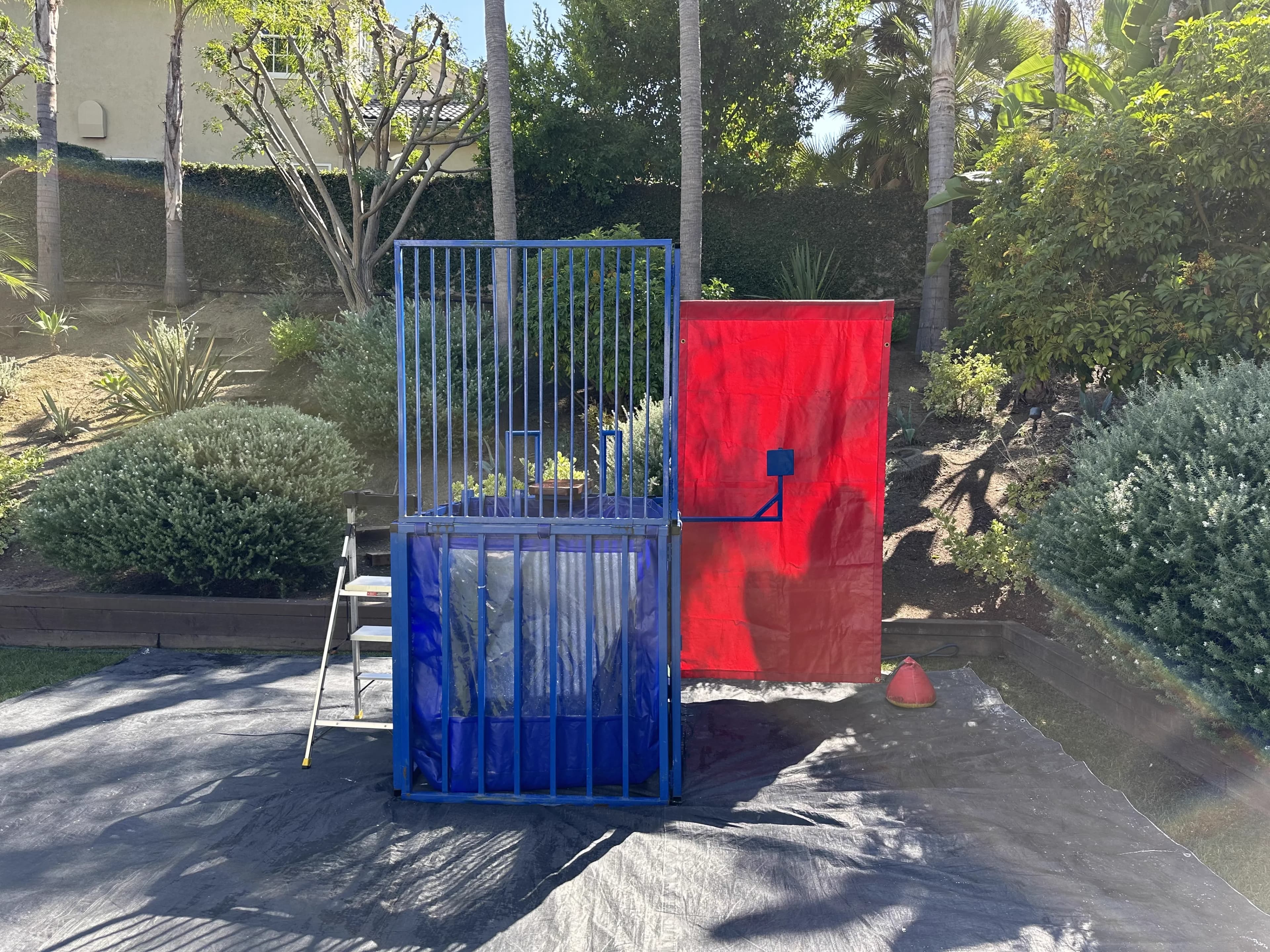 Full view of the Standard Blue Dunk Tank with splash guard, tank basin, and wide-angle seating platform visible.