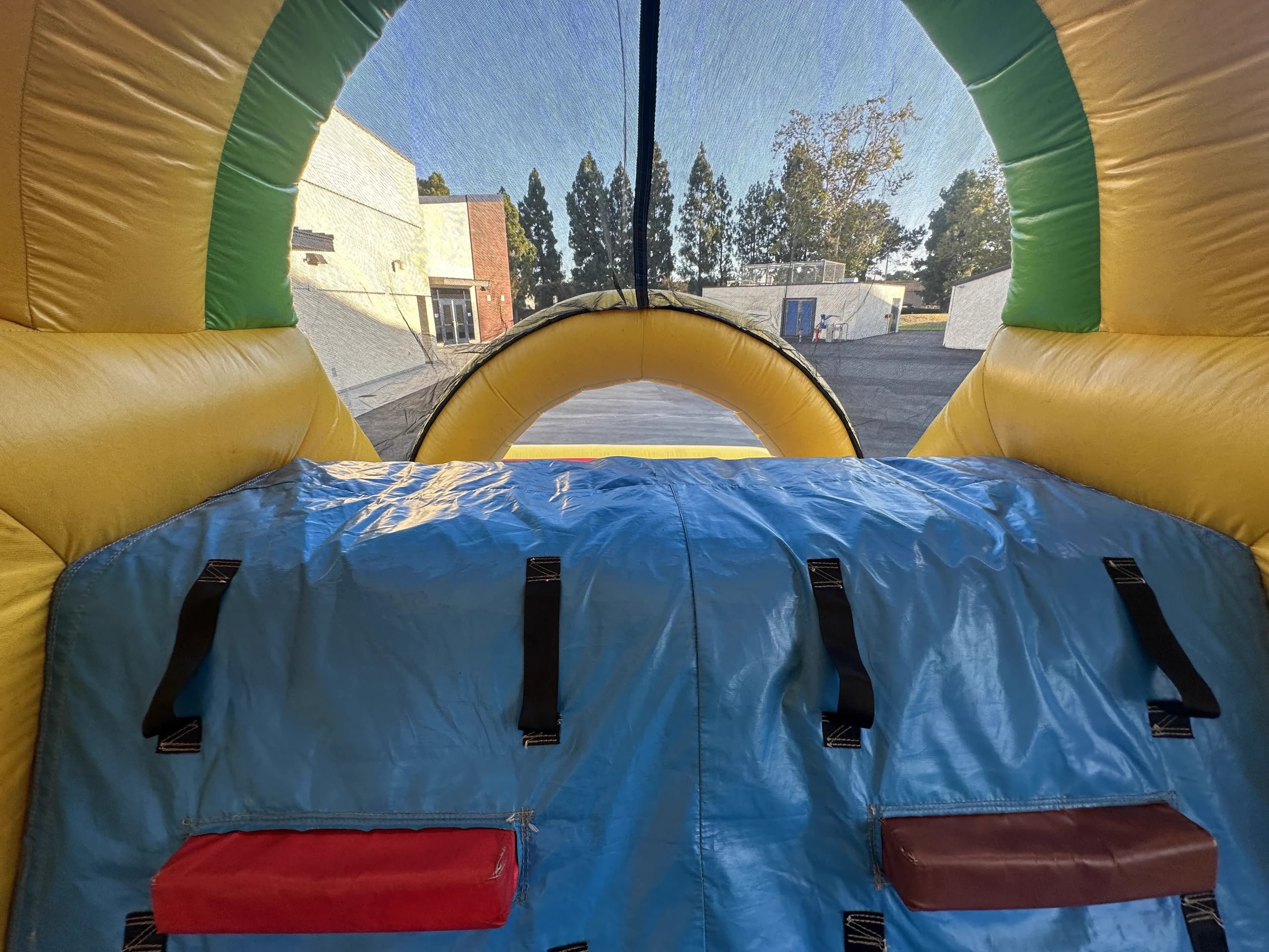 Close-up interior entry view of the Super 6 in 2 Fun Run Obstacle Combo showing the entrance arch and mesh flap from inside the course.