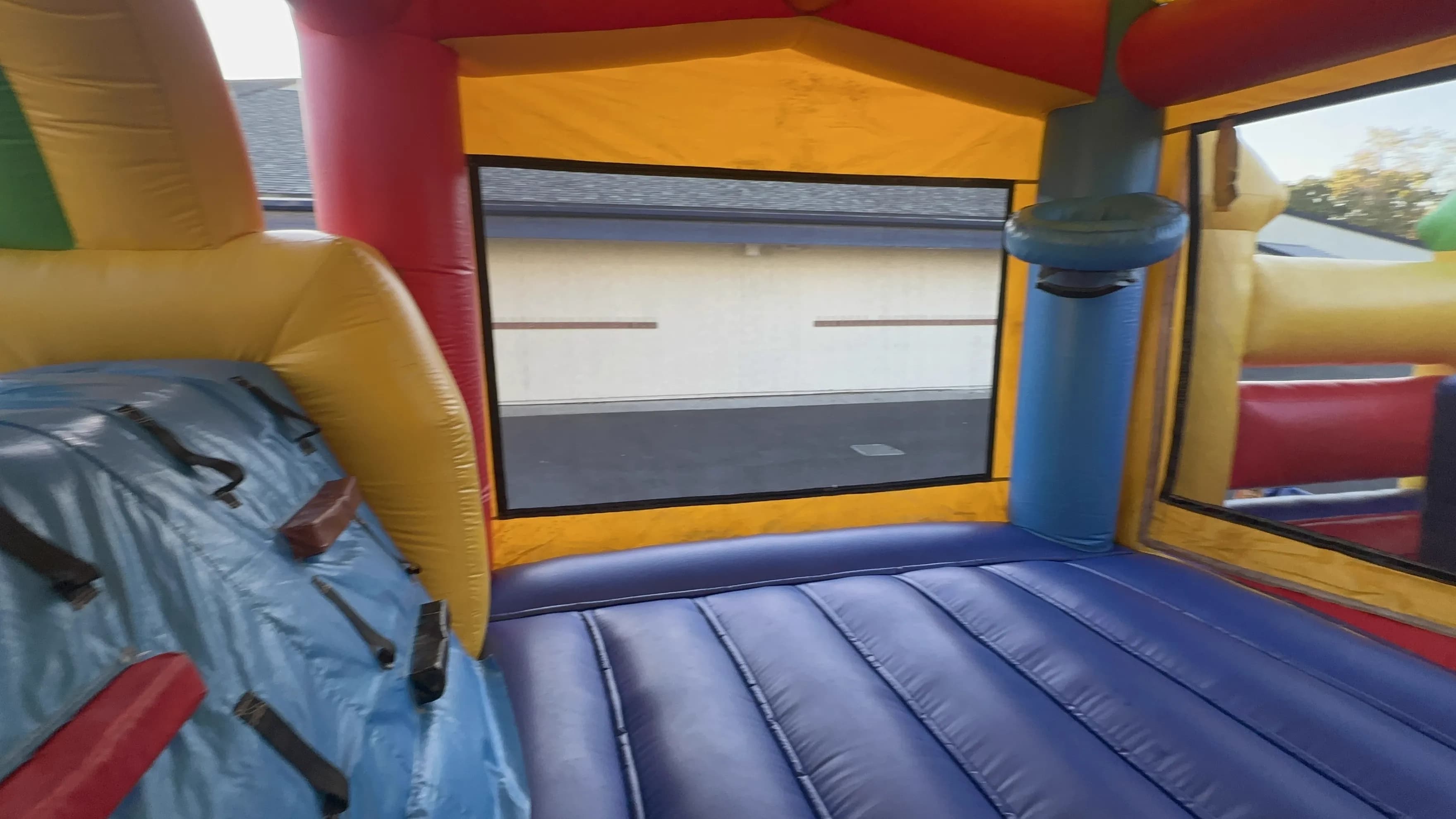 Close-up interior side wall view of the Super 6 in 2 Fun Run Obstacle Combo showing the mesh paneling and obstacle padding along the course edge.