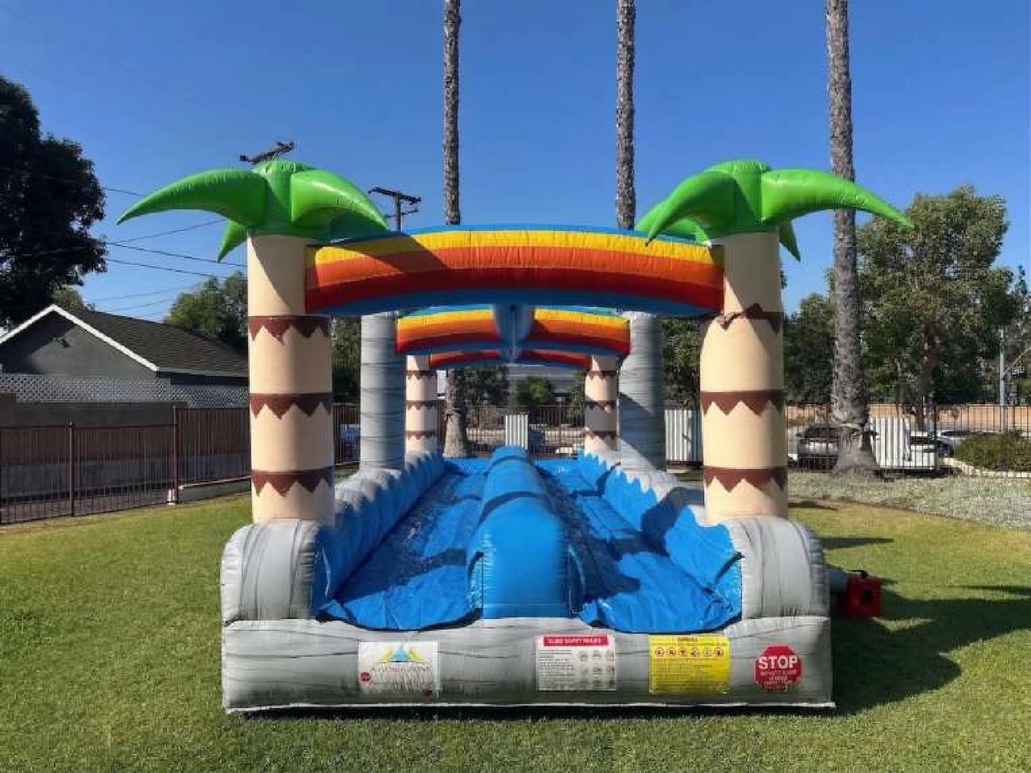 Outdoor front angle of the Tropical Slip n' Fun Splash set up for an event.