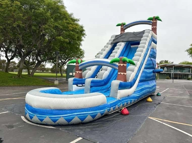 Outdoor front angle of the Tropical Surge Water Slide set up for an event.